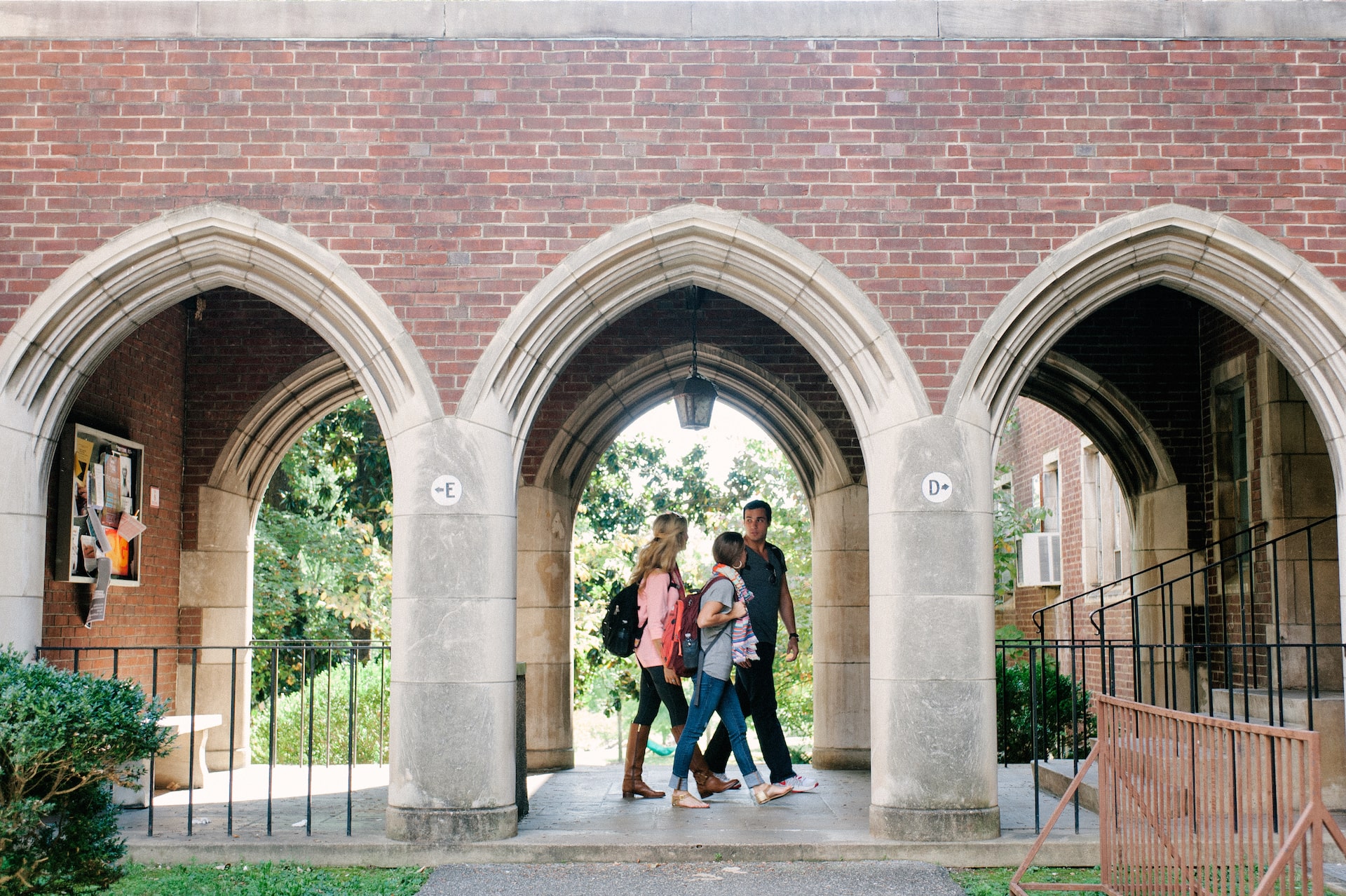 group of students walking between two buildings