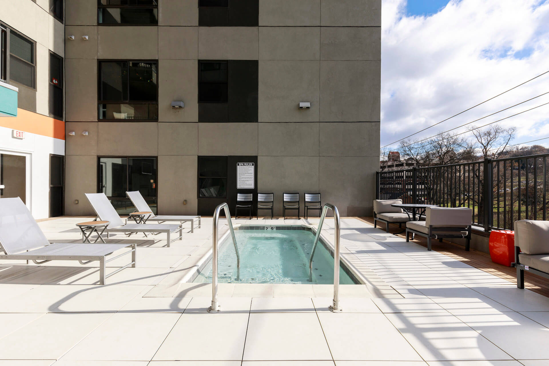 outdoor mini pool area with lounge chairs at slate at 901 apartments