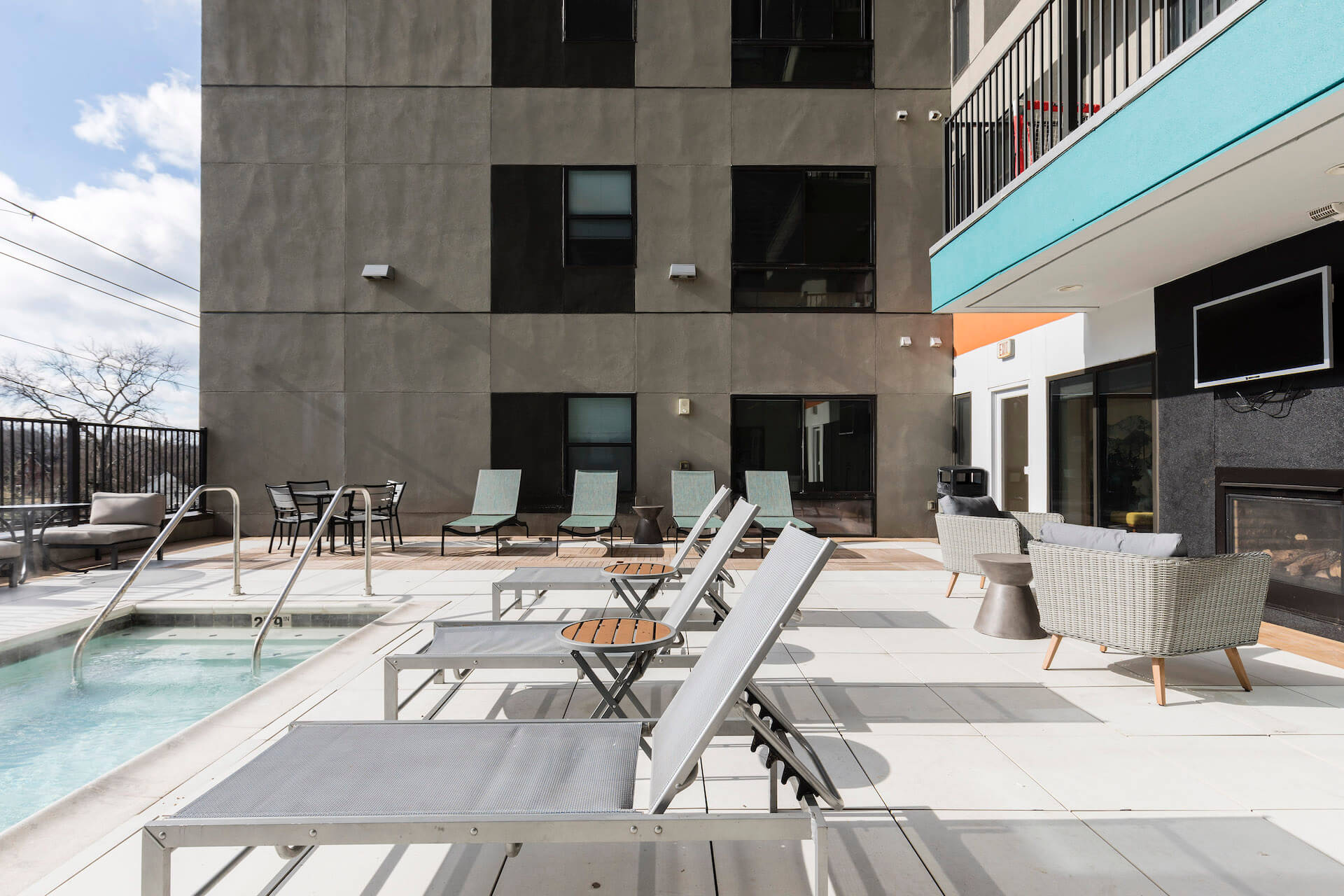 outdoor pool area with lounge chairs at slate at 901 apartments